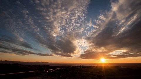 Blissful sunset alongside a highway with a cloudy sky Stock Footage 77549428