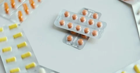 Blister with colorful capsules. Camera pans a top view of tablet quickly Stock Footage 78443448