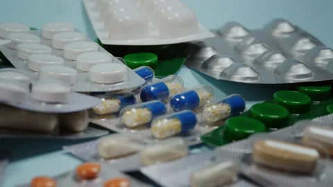Blister pack pills on blue background Stock Footage 155813570