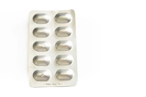Blister pack of ten silver capsules on white background medication pills pa.. Stock Photos