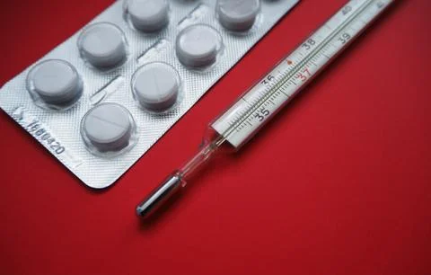 Blister packing tablets with a thermometer Stock Photos