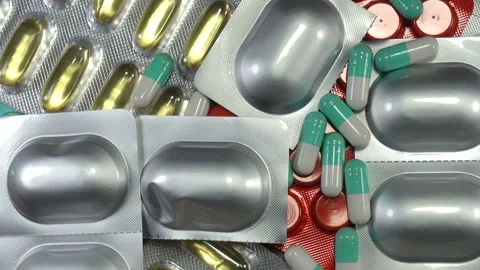 Blister pills fall on a pile of rotating medications Stock Footage 140757590
