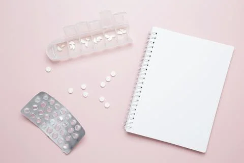 Blister of tablets and blank notebook. Concept of medicine, healthcare, and p Stock Photos