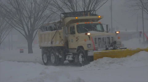 Blizzard 2016: Snow plow / salt truck followed by traffic Stock Footage 59969898