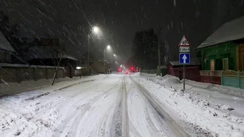 Blizzard against the backdrop of lights on poles in the city in winter at night Stock Footage 293684890