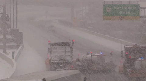 Blizzard and highway snow plows plowing snow in storm Stock Footage 44117830