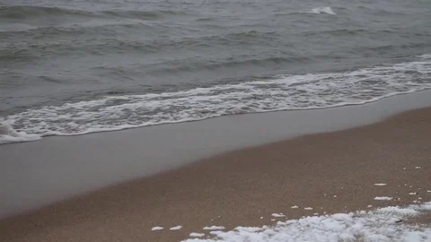 Blizzard and the running waves on the sandy snow coast of a reservoir Stock Footage 73512635