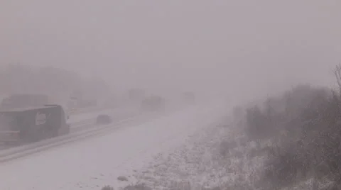 Blizzard and snowstorm on the highway with traffic cars and transport trucks Stock Footage 59172540