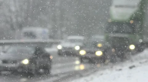 Blizzard on highway with slow moving vehicles (defocused) Stock Footage 10562873
