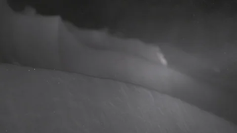 Blizzard at night, falling snow on a black background. snowstorm on a cold Stock Footage 127886055