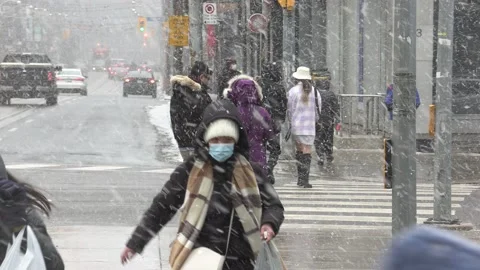Blizzard of snow and high wind with people and traffic in Toronto Stock Footage 171784130
