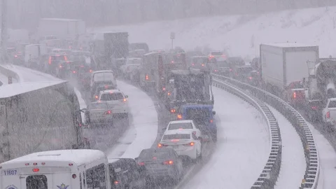 Blizzard with traffic jam and highway gridlock in winter snow storm Stock Footage 88219878