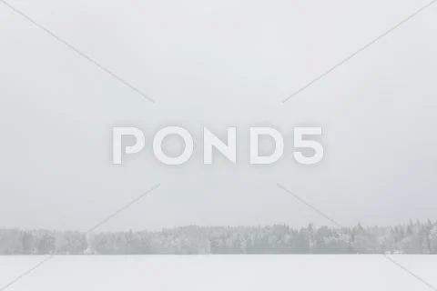 Blizzard winter landscape at frozen lake Stock Photos
