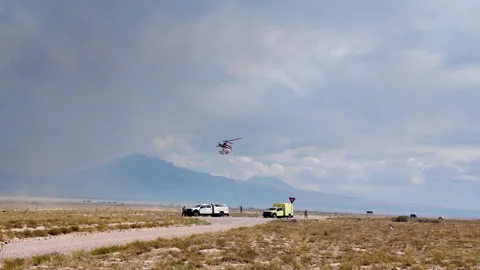 BLM fire trucks and a helicopter in the Utah desert Stock Footage 344619633