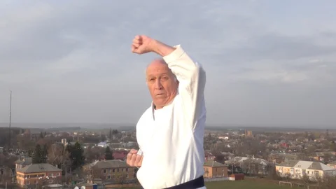 Block and punch in the performance of an old male athlete Stock Footage 127400984