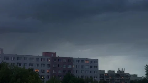 Block apartment housing construction under a threatening dark sky, dense rain Stock Footage 334951459