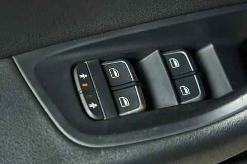 Block of buttons for controlling car windows and blocking the opening of rear Stock Photos