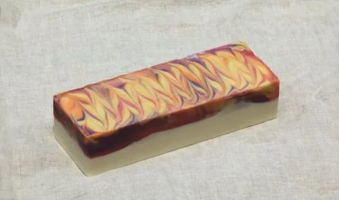 Block of cold process soap on linen backdrop 库存照片