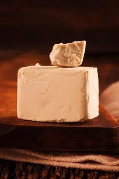 A block of compressed fresh yeast. Stock Photos