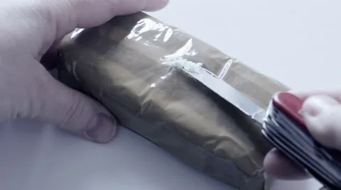 Block of drugs, taking sample with knife Stock Footage 22960873