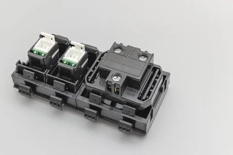 A block of electrical outlets and a network outlet on a gray background. 写真素材