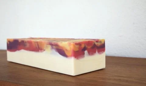 Block of handmade cold process soap on wooden surface 库存照片