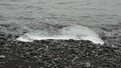 Block of ice on black and volcanic sand Stock Footage 318675346