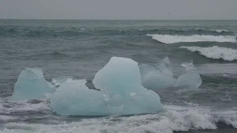 Block of ice on black and volcanic sand Stock Footage 318675387