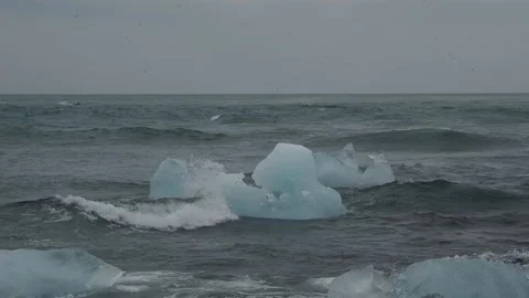 Block of ice on black and volcanic sand Stock Footage 318675442