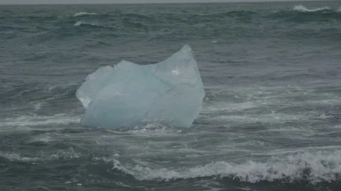 Block of ice on black and volcanic sand Stock Footage 318675559