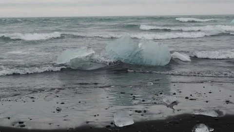 Block of ice on black and volcanic sand Stock Footage 318675646