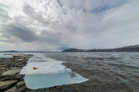 Block of ice by the sea Stock Photos