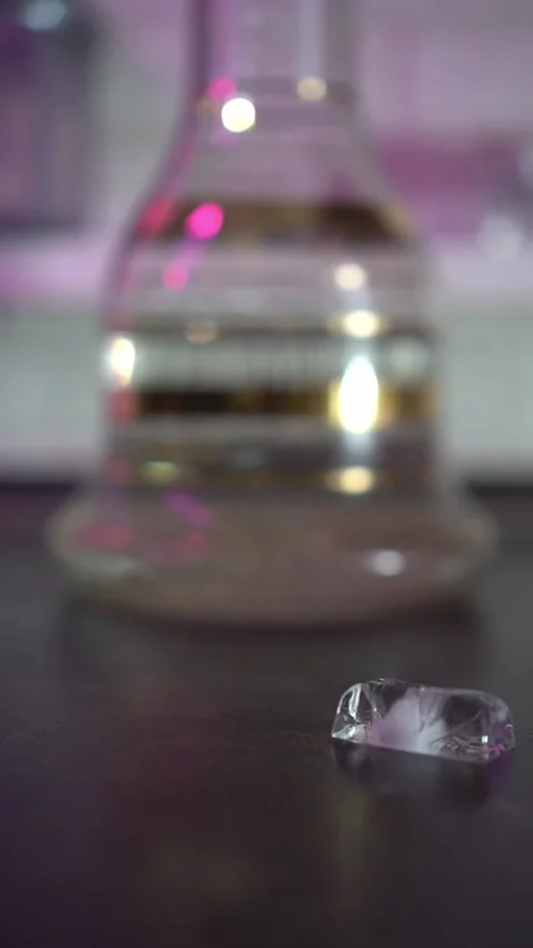 Block of ice slides across table to hookah glass base Stock-Footage 164462130