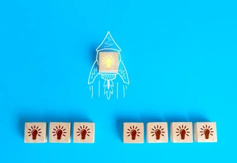 Block with the idea light bulb took off on an imaginary rocket doodle. Develo Stock Photos