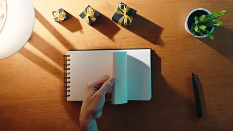 Block note on the office with presents and a lamp in the night Stock Footage 220116092