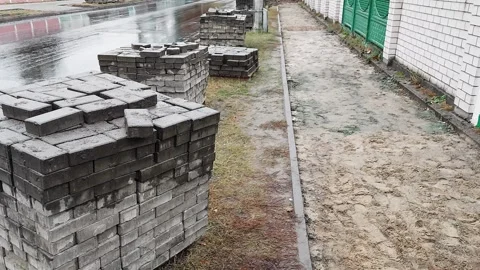Block of old concrete cobblestones removed from the sidewalk road for further Stock Footage 254665312