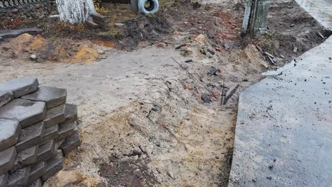 Block of old concrete cobblestones removed from the sidewalk road for further Stock Footage 254665661