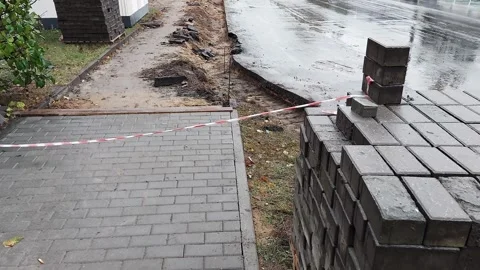 Block of old concrete cobblestones removed from the sidewalk road for further Stock Footage 256204273