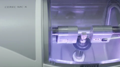 Block of porcelain in Cerec machine getting ready to be milled into dental crown Stock Footage 113723129
