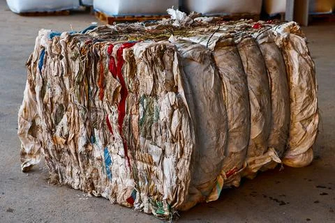 Block of pressed plastic material at recycling plant storage Stock Photos