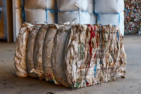 Block of pressed plastic material at recycling plant storage Stock Photos
