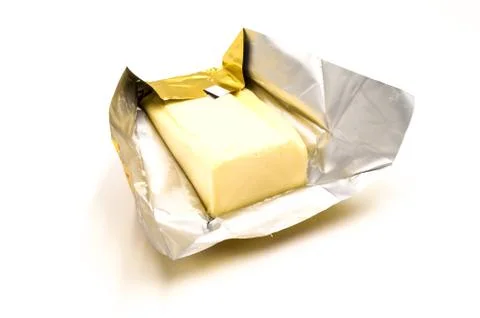 Block of rectangular fresh butter with packaging Foto stock