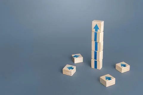 Block tower with arrows. Growth, development progress concept. Achieve succ.. Fotos de archivo