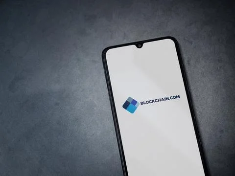 Blockchain.com app launch screen on smartphone on dark marble stone backgroun Stock Photos