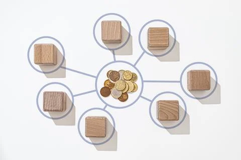 Blocks are arranged in a circular pattern around a cluster of coins, visually Stock Photos
