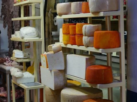 Blocks of Cheese on racks 库存照片
