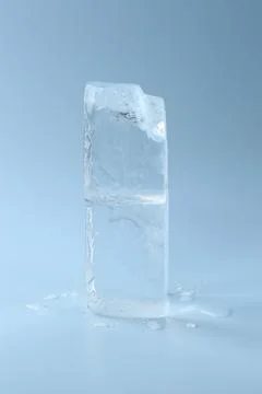 Blocks of clear ice on light blue background Foto stock