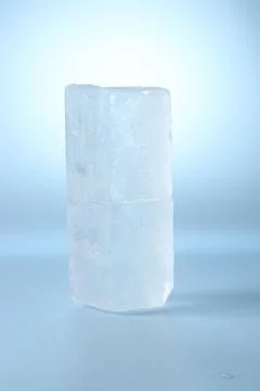 Blocks of clear ice on light blue background Stock Photos