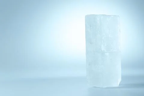 Blocks of clear ice on light blue background, space for text Stockfoto's