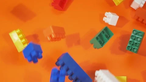 Blocks fall from the top to the orange background. Slow motion. 库存影片 143927729